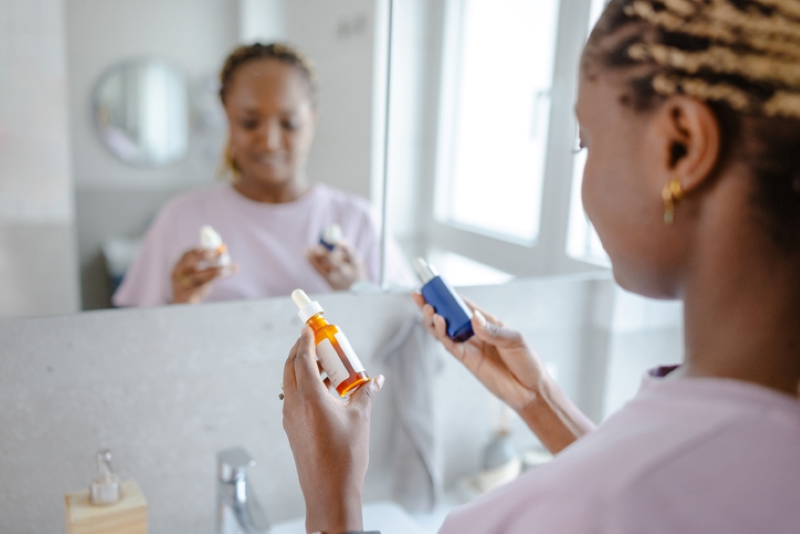Woman looking at two skincare products