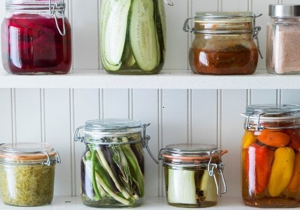 pantry with glass jars filled with fruits and vegetables